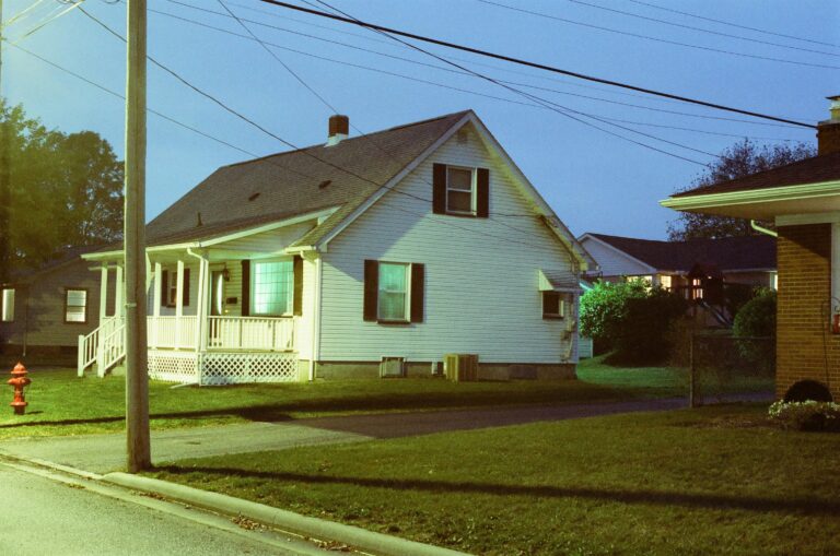 A modest single-family home seen from the street at dusk