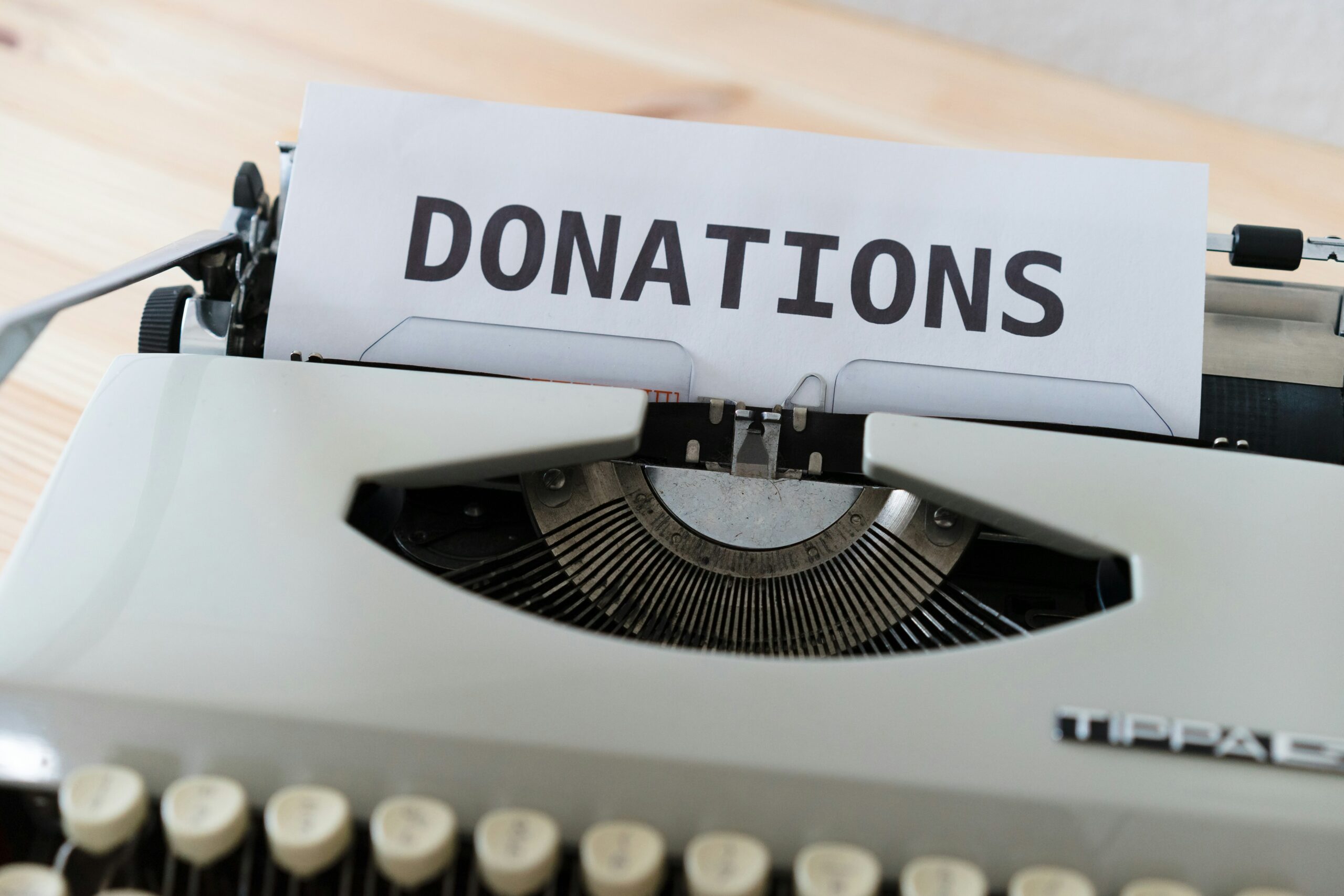 A typewriter with a sheet of paper reading DONATIONS