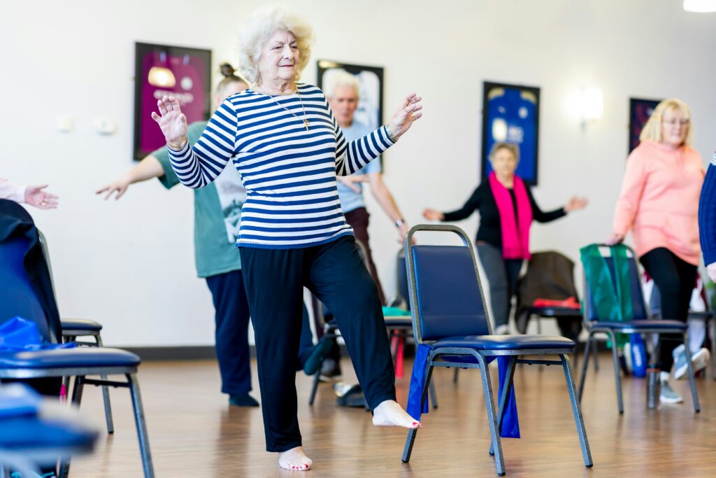A group exercise class for older adults using chairs