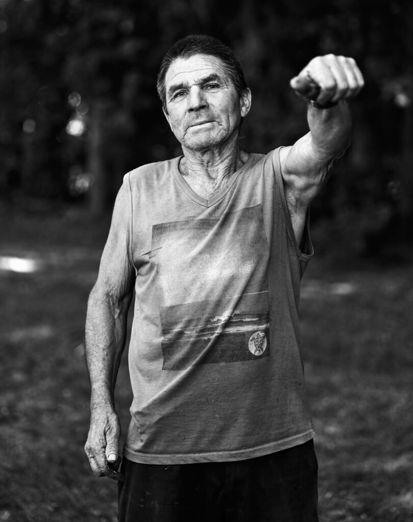 A black and white portrait of an older man, strong and composed